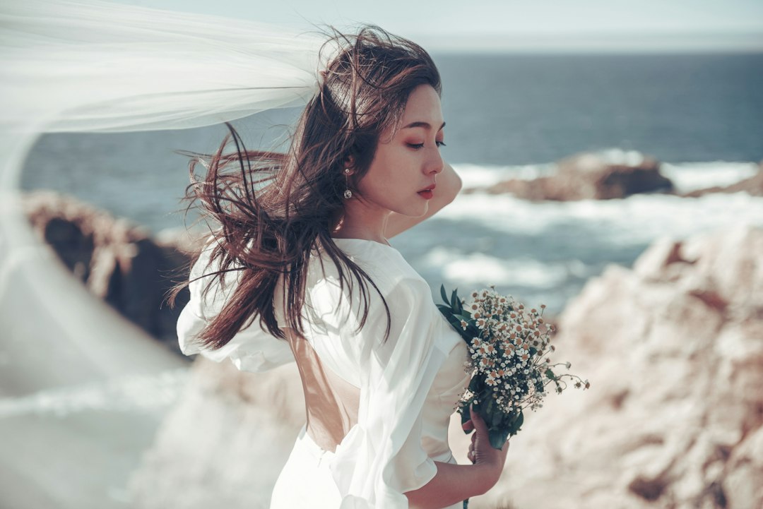 a-woman-in-a-white-dress-holding-a-bouquet-of-flowers-8d3wiaqnans